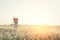 beautiful woman standing on flower field down to catching f