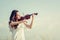 Beautiful Woman standing Playing the violin in the meadow