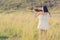 Beautiful Woman standing Playing the violin in the meadow