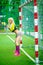 beautiful woman stands at football field at gate