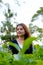 A beautiful woman stands among the tea leaves in the city of Solo - Indonesia in the afternoon.