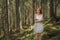Beautiful woman stays alone in fairytale green forest