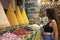 Beautiful woman in a store selling spices enjoying them in the Jemaa el Fna square in the city of Marrakech in Morocco