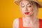 Beautiful woman in straw hat. Closed eyes. Yellow summer mood background. pensive dreamy face