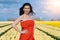 Beautiful Woman in summer dres standing in colorful tulip flower fields in Amsterdam region, Holland, Netherlands