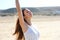 Beautiful woman taking deep breath enjoying fresh air on the beach