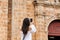 Beautiful woman taking pictures of the San Pedro Claver church located in the walled city of Cartagena de Indias