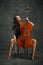 Beautiful woman, talented, passionate cellist looking upward, reflecting creativity and inspiration while playing