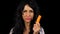 Beautiful woman tasting and eating a carrot