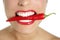 Beautiful woman teeth eating red pepper