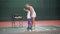 Beautiful woman tennis coach teaching little girl how to play tennis.