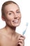 Beautiful woman with toothbrush. Dental care background. Closeup on young woman showing toothbrush. Beautiful young woman