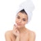 Beautiful woman with a towel on his head. Removing makeup.