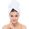 Beautiful woman with a towel on his head. Removing makeup.