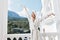 beautiful woman with a towel on my head in a white bathrobe staying on the balcony in a hotel Mountain View