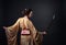 Beautiful woman in traditional Japanese kimono with katana