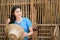 Beautiful woman in a traditional Thai dress, blue in rustic Thai atmosphere