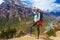 Beautiful Woman Traveler Backpacker Mountains Path.Young Girl Looking Right Way and Take Rest.North Summer Snow