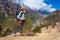 Beautiful Woman Traveler Backpacker Mountains Path.Young Girl Looks Right Way and Take Rest.North Summer Snow Landscape