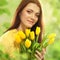 Beautiful woman with tulips bouquet of flowers