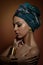 Beautiful woman with turban. Young attractive female with turban and golden accessories. Beauty fashionable woman