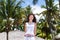 Beautiful woman under tropical palm trees