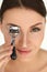 Beautiful Woman Using Eyelash Curler On Curly Long Eyelashes