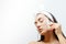 Beautiful woman using Natural Gouache Scraper Massager over face skin