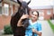 Beautiful woman, veterinarian stroking a horse