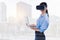 Beautiful woman in VR headset posing with laptop