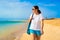 Beautiful woman walking on sunny beach Santa Maria, Sal Island, Cape Verde