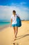 Beautiful woman walking on sunny beach Santa Maria, Sal Island, Cape Verde