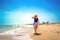 Beautiful woman walking on sunny beach Santa Maria, Sal Island, Cape Verde