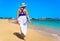 Beautiful woman walking on sunny beach Santa Maria, Sal Island, Cape Verde