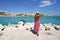 Beautiful woman walking towards Otranto bay admiring panoramic, Apulia, Italy