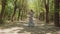 Beautiful woman walks along a forest path and dancing,summer garden