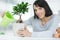 beautiful woman watering bonsai tree