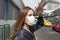 Beautiful woman wearing anti dust mask protect air pollution and pm 2.5 on street city