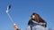 Beautiful woman wearing dark sunglasses taking selfie outdoors in the urban park during sunny spring day on blue sky