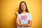 Beautiful woman wearing fanny t-shirt with irony comments over isolated yellow background smiling with happy face looking and