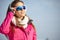 Beautiful woman wearing goggles in snowy winter