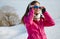 Beautiful woman wearing goggles in snowy winter