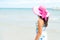 Beautiful woman wearing hat beach and sunglasses stand on hands over sandy beach