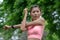 Beautiful woman wearing orange sports warm up before exercise. Sporty young woman warming up before running in the public