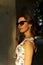 Beautiful woman wearing sunglasses at sunset. Beauty and Fashion luxury style. Golden hour photo