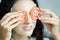 A beautiful woman wearing a towel and a white bathrobe has mask on face-covering eyes with sliced tomatoes with happy and relaxing