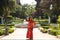 A beautiful woman wears a traditional Moroccan dress in red and embroidered in gold and silver. The girl poses for wedding photos