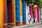 Beautiful woman on white dress walking alone at the colorful streets of the colonial walled city of Cartagena de Indias