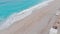 Beautiful woman woman on beach sitting in sand looking at ocean