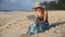 Beautiful Woman Working On Laptop on the Beach